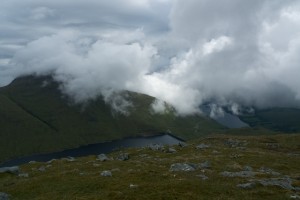 Clouds shifting over lake and hills